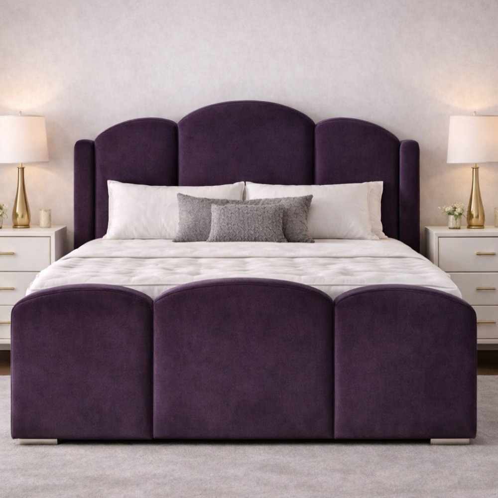 Purple velvet wooden bed with curved winged headboard and matching footboard in a stylish bedroom.