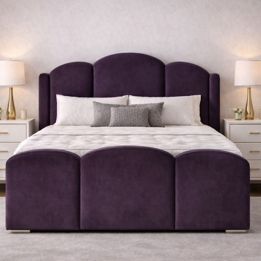 Purple velvet wooden bed with curved winged headboard and matching footboard in a stylish bedroom.