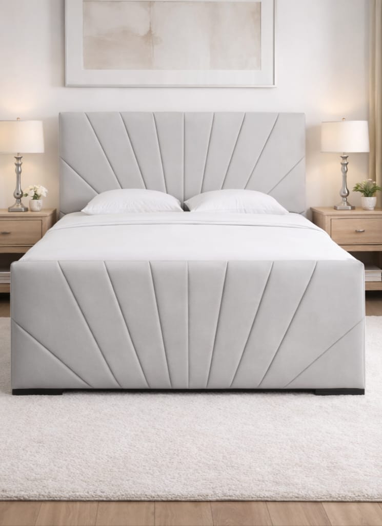White upholstered bed in a bedroom setting with matching nightstands and headboard.