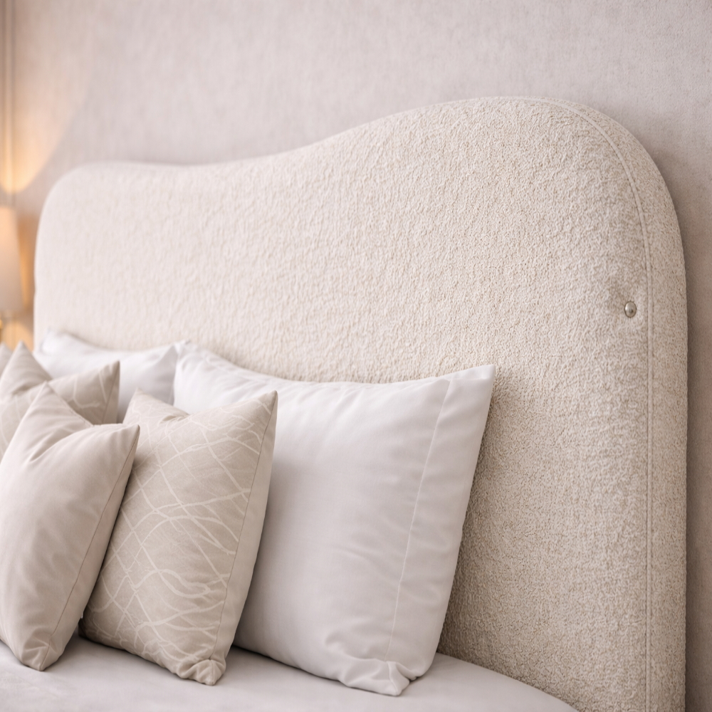 The Blush Haven Kids Bed close up of cream boucle curved headboard with soft neutral pillows in modern kids bedroom setting.