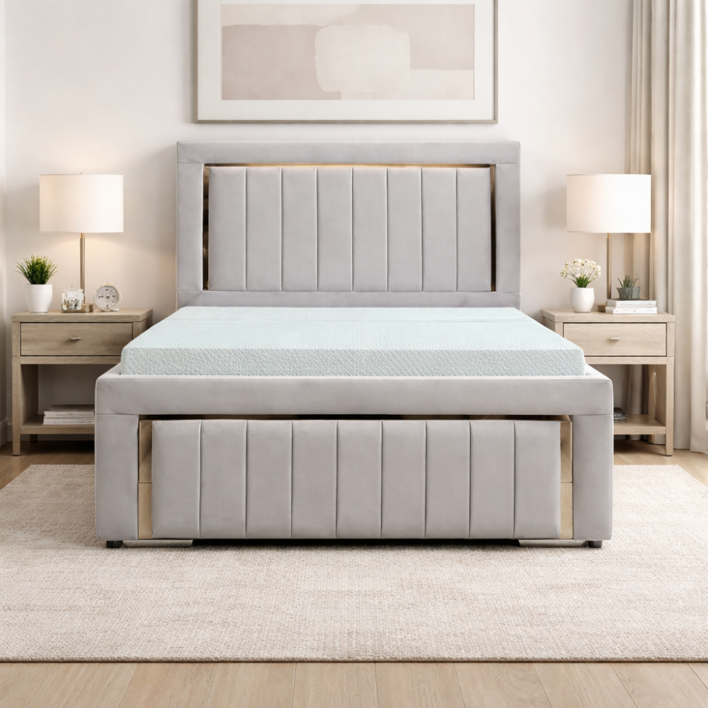 The Carter Luxury Panel Bed in soft grey upholstery with vertical panels, matching footboard and modern bedside tables in bedroom setting.