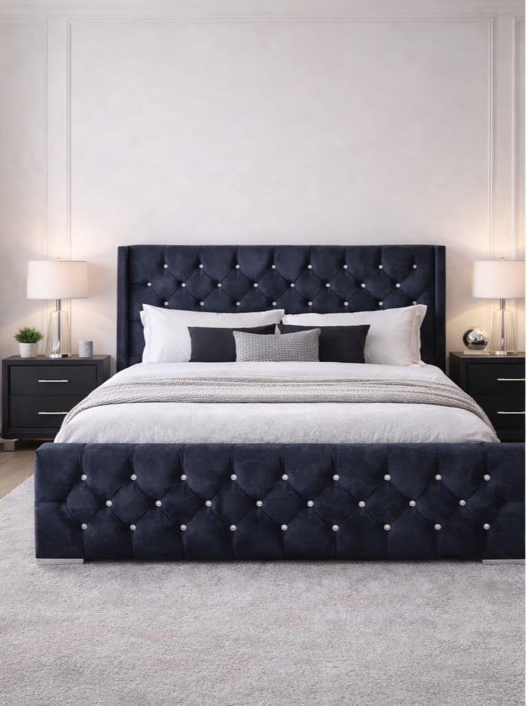 Navy tufted bed with white bedding in a bedroom setting