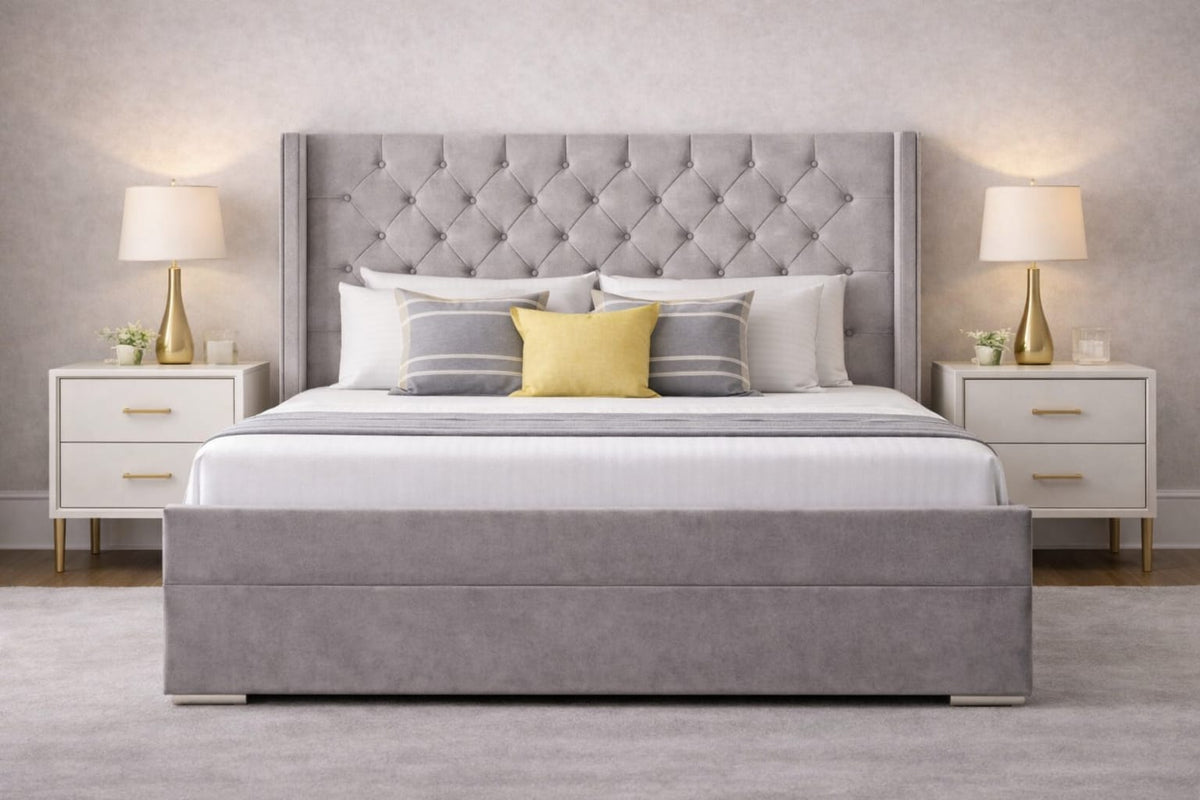 Gray upholstered bed with matching headboard in a bedroom setting.