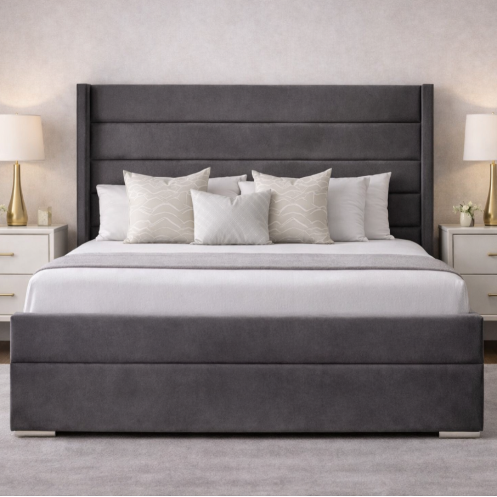 The Imperion Wingback Luxury Bed in grey velvet with tall winged headboard, cushioned base and elegant bedside tables in stylish UK bedroom.