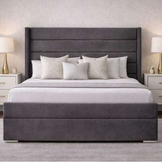 The Imperion Wingback Luxury Bed in grey velvet with tall winged headboard, cushioned base and elegant bedside tables in stylish UK bedroom.