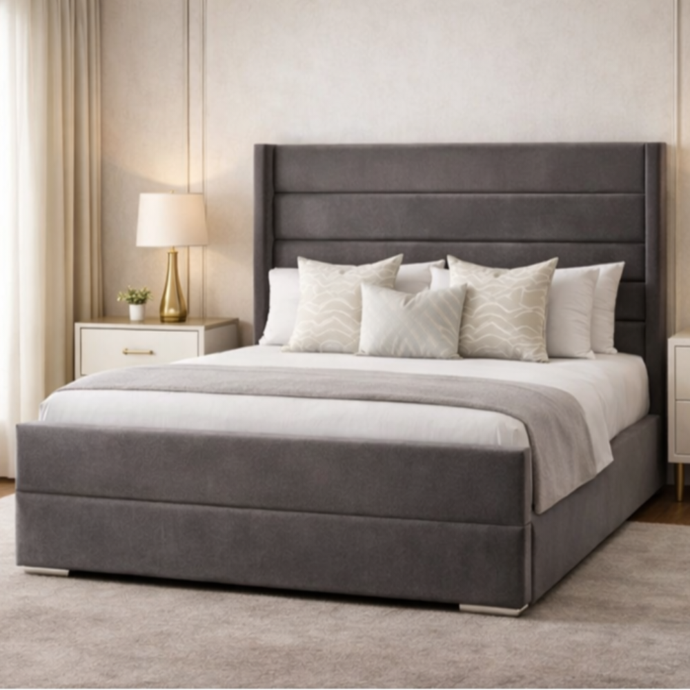 The Imperion Wingback Luxury Bed in dark grey fabric with tall winged headboard and padded base in modern UK bedroom setting.