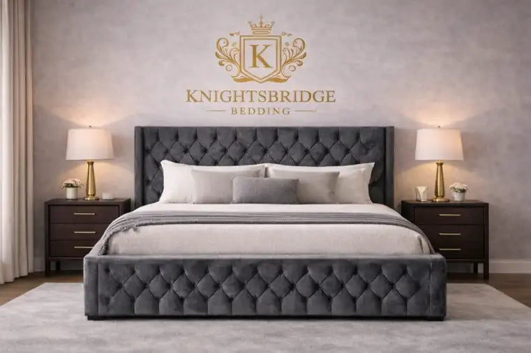 Gray tufted bed with matching nightstands and lamps in a bedroom setting, featuring the Knightsbridge Bedding logo.