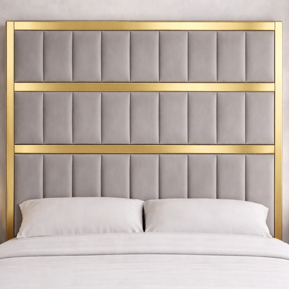 Close up of grey upholstered panel bed with gold frame, tall padded headboard and soft neutral bedding in bedroom setting.