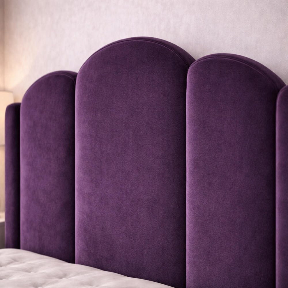 The Mayfair Wingback Luxury Bed close up of plush purple velvet scalloped headboard with soft curved panels in modern bedroom.