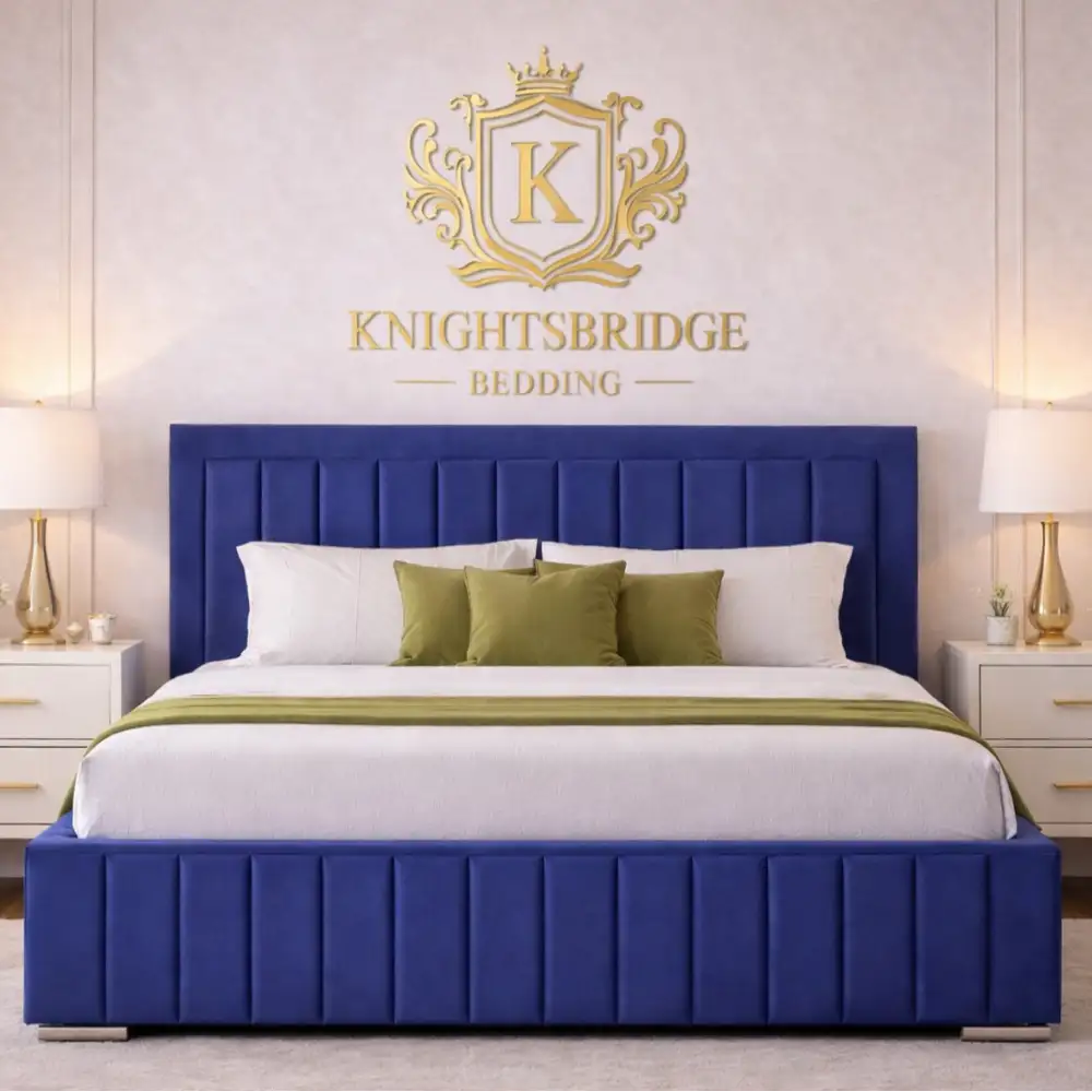 Blue bed with white bedding and green pillows in a bedroom setting, featuring the Knightsbridge Bedding logo.