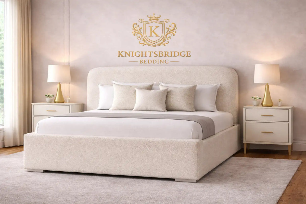 Beige upholstered bed with Knightbridge Bedding logo in a bedroom setting.