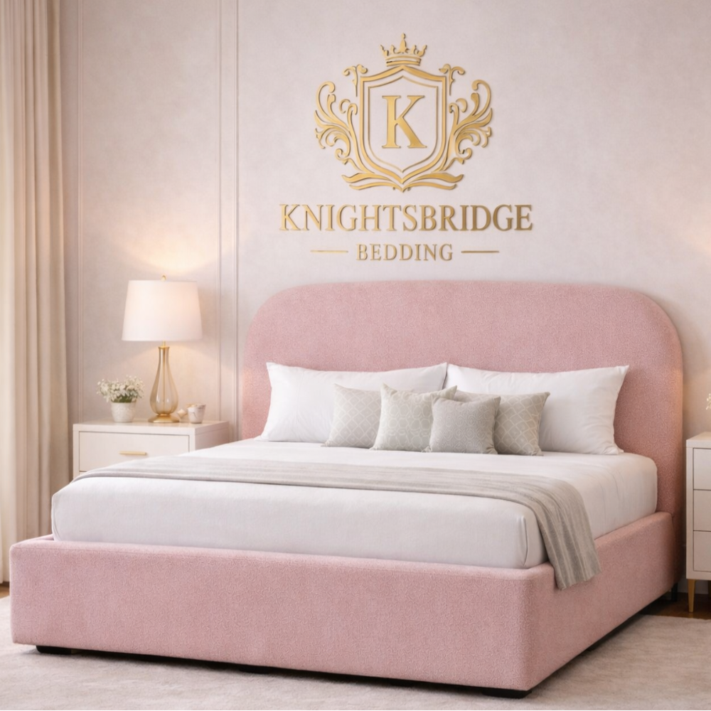 The Tate Bed Frame in blush pink upholstery with rounded headboard and padded base styled in soft neutral bedroom interior.