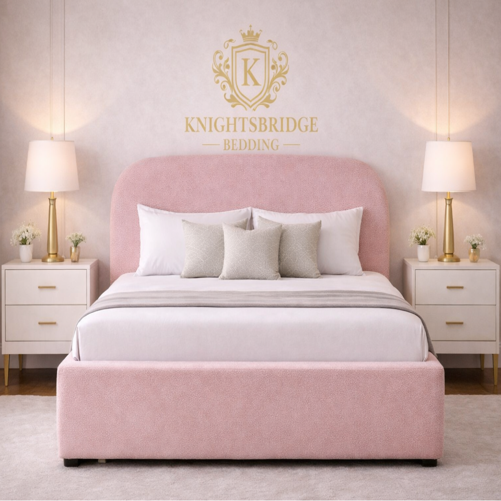 The Tate Bed Frame in blush pink upholstery with rounded headboard and padded frame styled in elegant modern bedroom interior.