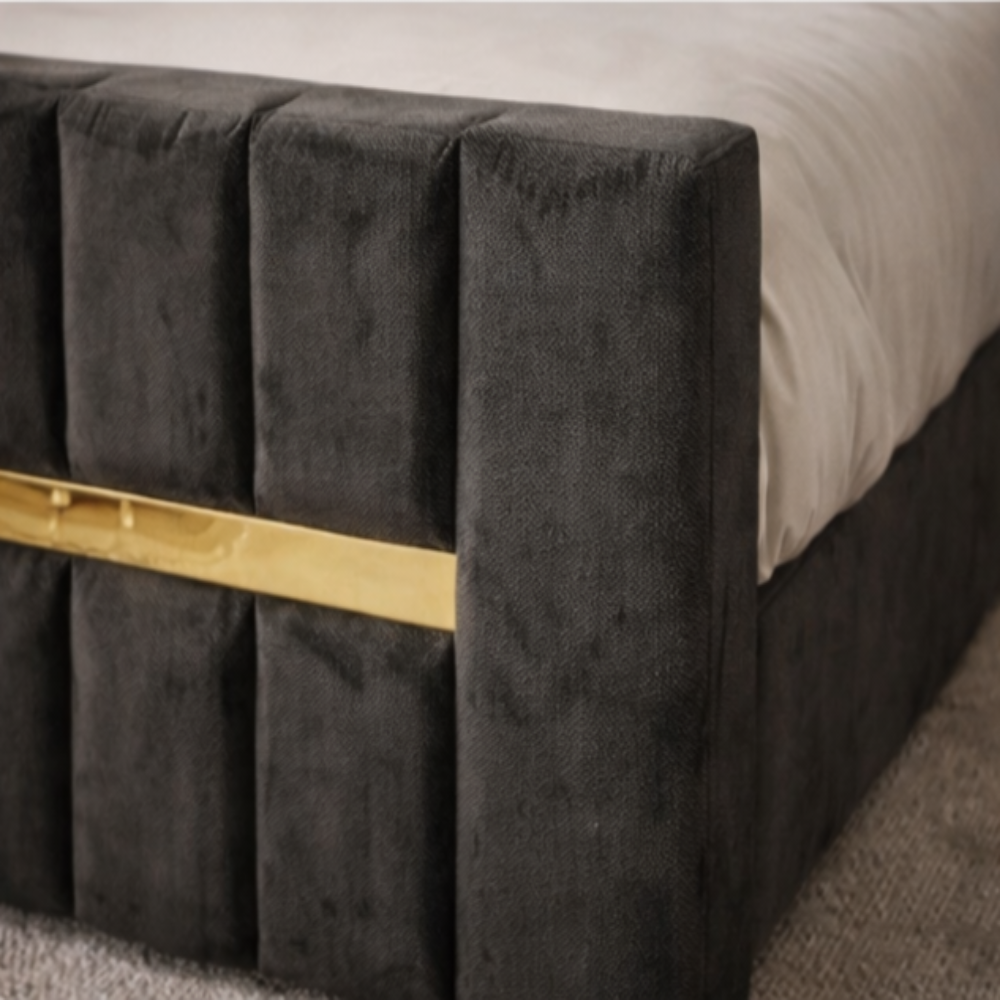 The Waterloo Luxury Panel Bed close up showing dark velvet panels and gold accent bar on upholstered footboard design.